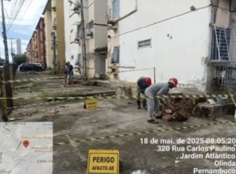 Equipe em atividade junto à base de edifício residencial
